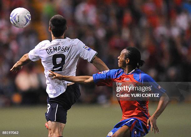 Costa Rican Junior Diaz fights for the ball with US Clinton Demsey during their FIFA World Cup South Africa-2010 qualifier on June 3, 2009 at the...