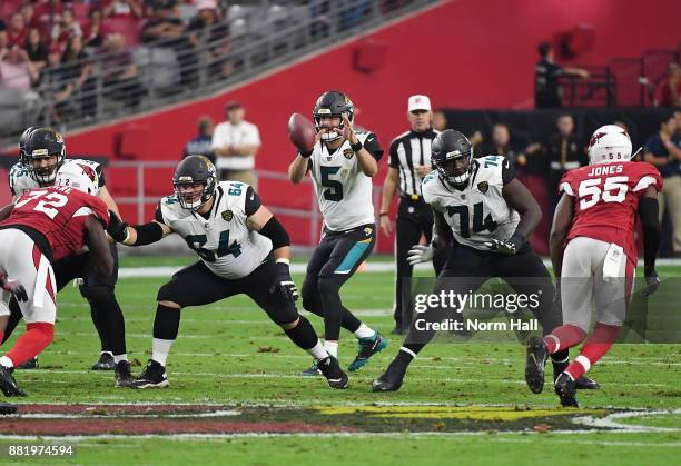 Blake Bortles of the Jacksonville Jaguars takes the snap from the shotgun formation as teammates Cam Robinson and Chris Reed pass block against the...