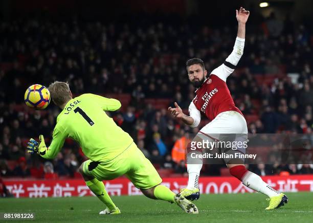 Olivier Giroud of Arsenal scores his sides fifth goal past Jonas Lossl of Huddersfield Town during the Premier League match between Arsenal and...