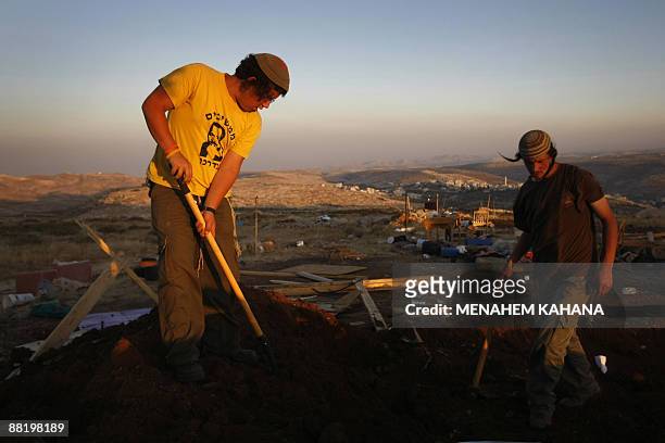 Jewish settlers rebuild the destroyed Migron outpost in the occupied West Bank on June 3, 2009. Israeli security forces destroyed nine tin huts that...