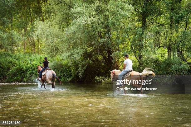 couple riding horses in italy - abruzzo national park stock pictures, royalty-free photos & images