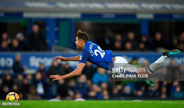Everton's English striker Dominic Calvert-Lewin goes down after being fouled in the box by West Ham United's English goalkeeper Joe Hart to win a...