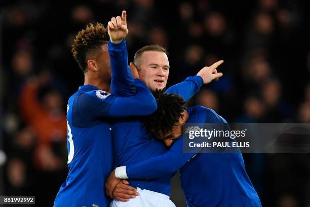 Everton's English striker Wayne Rooney celebrates scoring his third goal to complete his hattrick during the English Premier League football match...