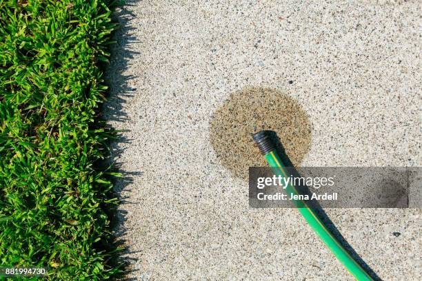 garden hose with wet spot - hosepipe stock pictures, royalty-free photos & images