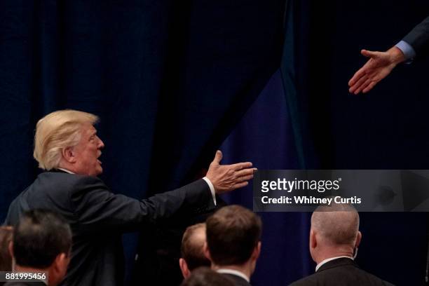 President Donald Trump greets members of the crowd after giving a speech on tax reform at the St. Charles Convention Center on November 29, 2017 in...