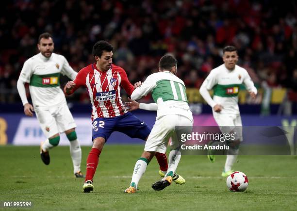 Nico Gaitan of Atletico Madrid in action against Diego Benito of Elche during the King's Cup soccer match between Atletico Madrid and Elche at Wanda...