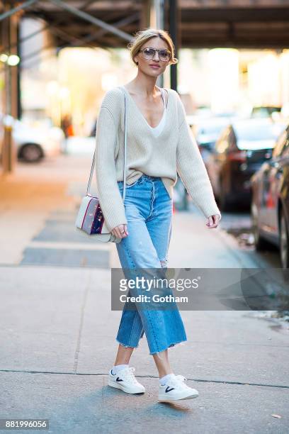 Martha Hunt is seen wearing a Khaite sweater, RE/Done jeans, Treyton shoes with a Byredo hangbag and vintage sunglasses in Chelsea on November 29,...