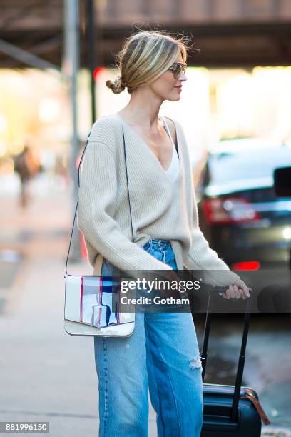 Martha Hunt is seen wearing a Khaite sweater, RE/Done jeans, Treyton shoes with a Byredo hangbag and vintage sunglasses in Chelsea on November 29,...