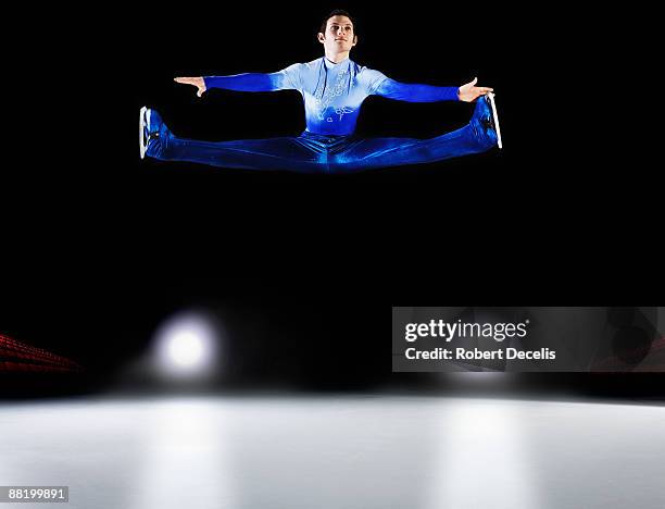 figure skater performing jump. - figure skating man stock pictures, royalty-free photos & images