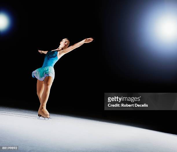 female figure skater, performing on ice. - eiskunstlauf wettbewerb stock-fotos und bilder