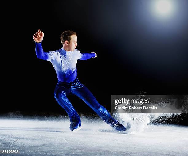 figure skater creating spray of ice. - winter sports stock pictures, royalty-free photos & images