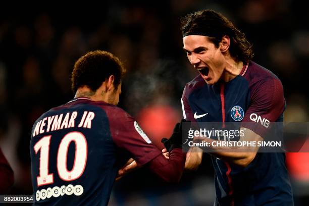 Paris Saint-Germain's Uruguayan forward Edinson Cavani celebrates with Paris Saint-Germain's Brazilian forward Neymar after scoring a goal during the...