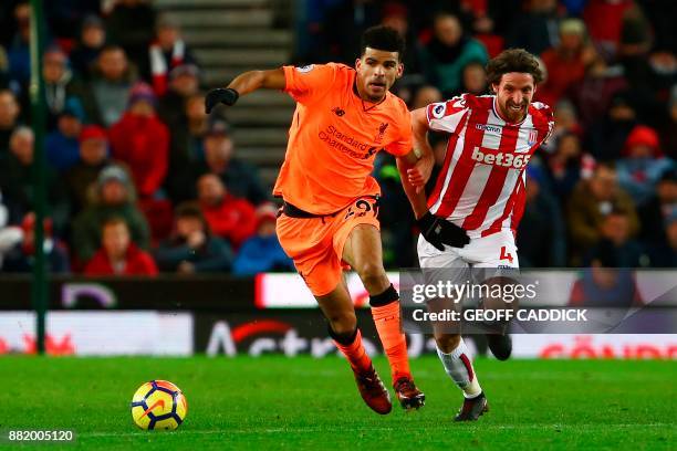 Liverpool's English striker Dominic Solanke vies with Stoke City's Welsh midfielder Joe Allen during the English Premier League football match...