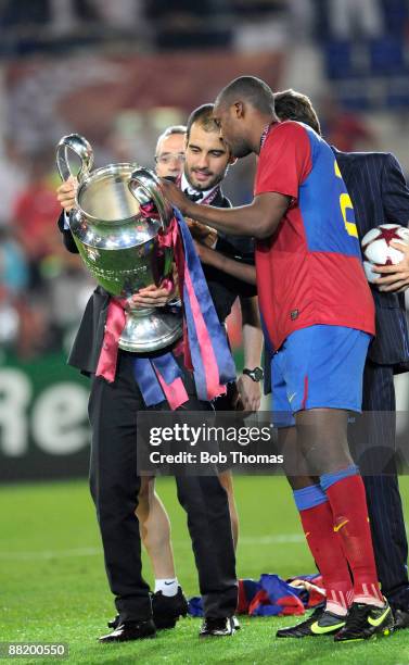 Barcelona coach Josep Guardiola holds the trophy with Yaya Toure after the UEFA Champions League Final match between Barcelona and Manchester United...