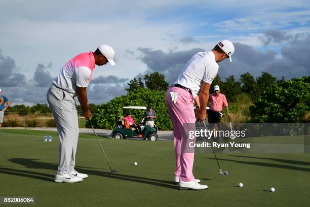 Tiger Woods and Justin Thomas have a putting contest on the practice green during practice for the Hero World Challenge at Albany course on November...