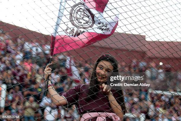 Fan of Lanus holds a flag and poses for a photo before the second leg match between Lanus and Gremio as part of Copa Bridgestone Libertadores 2017...