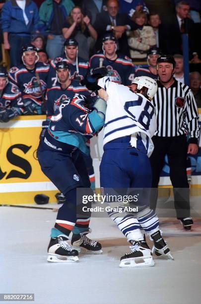 Mick Vukota of the New York Islanders fights with Tie Domi of the Toronto Maple Leafs during NHL game action on October 10, 1995 at Maple Leaf...