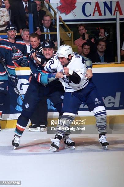 Mick Vukota of the New York Islanders fights with Tie Domi of the Toronto Maple Leafs during NHL game action on October 10, 1995 at Maple Leaf...