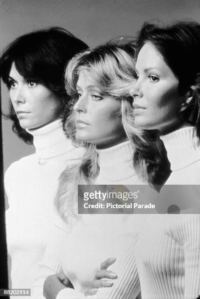 Promotional portrait of, from left, American actresses Kate Jackson, Farrah Fawcett, and Jaclyn Smith, all dressed in matching turtleneck sweaters,...