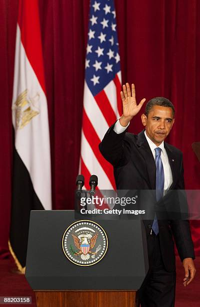President Barack Obama waves on leaving the podium following his key Middle East speech at Cairo University June 4, 2009 in Cairo, Egypt. In his...