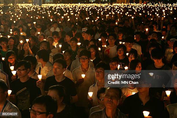Thousands of protestors hold candles during a candlelight vigil for the 20th anniversary of June 4 Tiananmen Square Massacre in Beijing at Victoria...