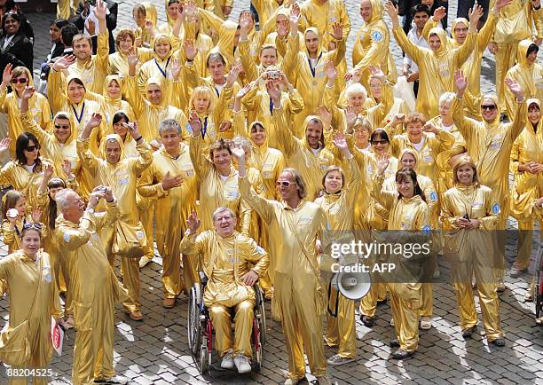 Clad in golden outfits a group of Polish citizens stage an action to celebrate the 20th anniversary of the fall of communism in Poland, on June...