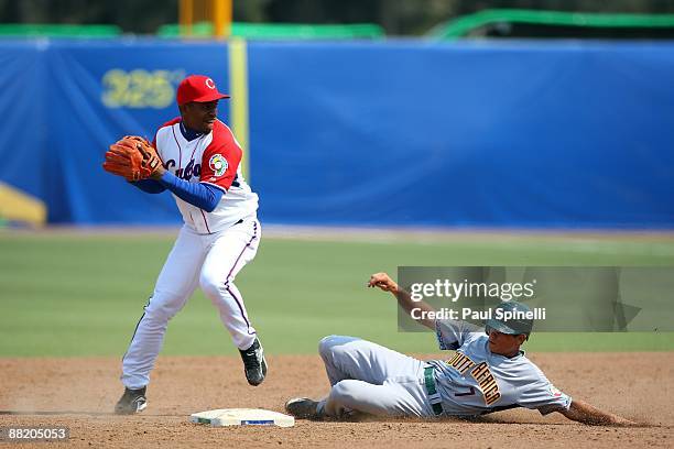 Luis Miguel Navas of Cuba tags second base for a force out on Anthony Phillips of South Africa during the Pool B, game one in the first round of the...