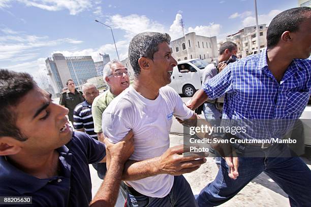 Rafter is detained by Cuban security officers after seven men failed in an attempt to leave the island at the Malecon waterfront on June 4, 2009 in...