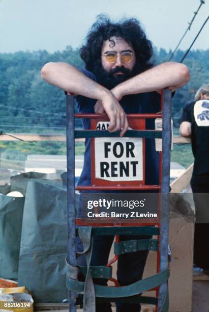 Portrait of American musician Jerry Garcia from the band the Grateful Dead backstage at the Woodstock Music and Arts Fair in Bethel, New York, August...