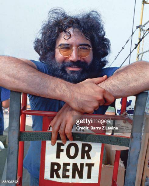 Portrait of American musician Jerry Garcia from the band the Grateful Dead backstage at the Woodstock Music and Arts Fair in Bethel, New York, August...