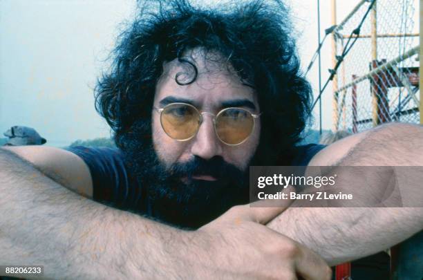 Portrait of American musician Jerry Garcia from the band the Grateful Dead backstage at the Woodstock Music and Arts Fair in Bethel, New York, August...