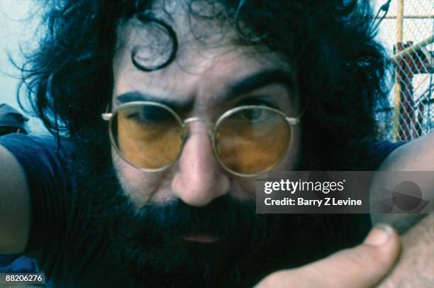 Portrait of American musician Jerry Garcia from the band the Grateful Dead backstage at the Woodstock Music and Arts Fair in Bethel, New York, August...