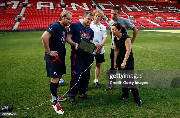 England's kicking coach Jon Callard gives coaching tips to Chris Foy of the Daily Mail and Gail Davis of Sky Sports News as England's Andy Goode and...