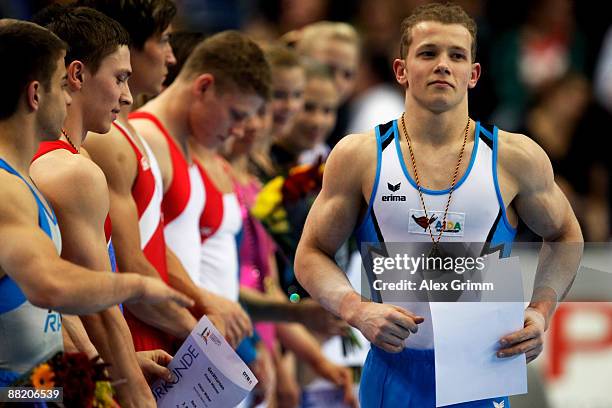 German gymnast Fabian Hambuechen walks past his competitors after an award ceremony at the German individual championship during the German...