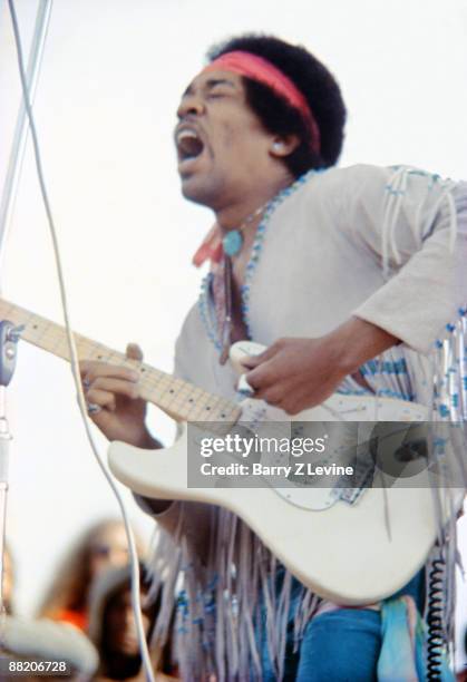 American musician Jimi Hendrix performs with his band, Gypsy Sun And Rainbows, onstage at the Woodstock Music and Arts Fair in Bethel, New York,...