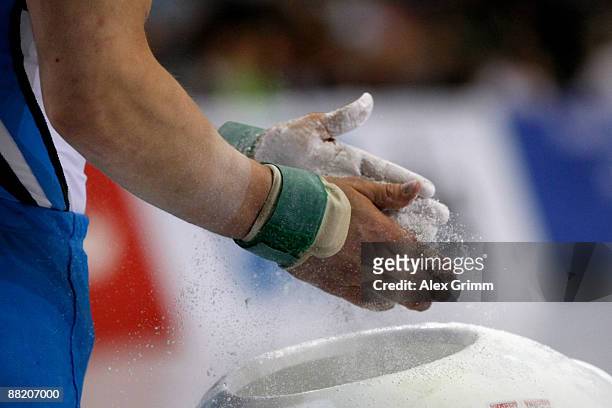 German gymnast Fabian Hambuechen prepares with magnesia before his pommel horse performance at the German individual championship during the German...