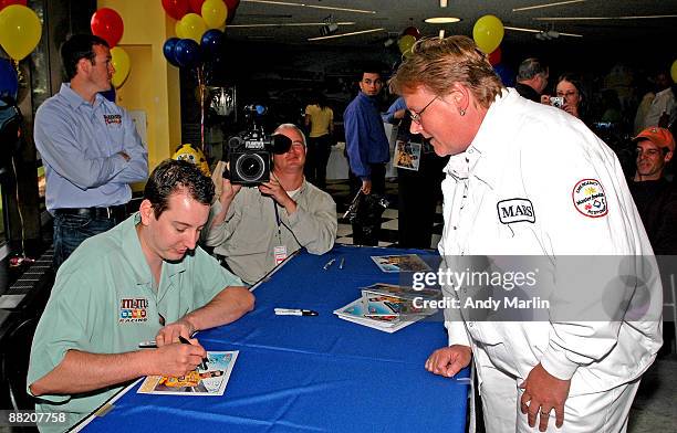 Driver Kyle Busch signs an autograph for a Mars employee during Mars Employee Appreciation Day at Mars Headquarters on June 4, 2009 in Hackettstown,...