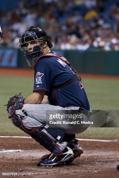 Joe Mauer of the Minnesota Twins crouches behind the plate during a game against the Tampa Bay Rays at Tropicana Field on May 29. 2009 in St....