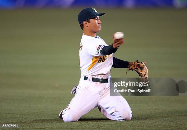 Shortstop Anthony Phillips of South Africa throws from his knees during the Pool B, game three against Mexico in the first round of the 2009 World...