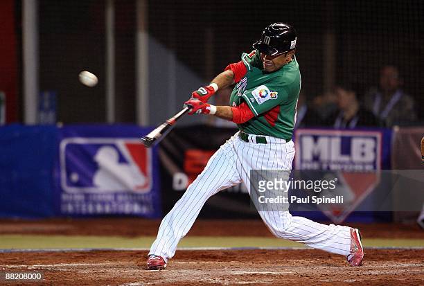 Shortstop Oscar Robles of Mexico gets a base hit in the top of the eighth inning that puts runners at first and third base with one out during the...