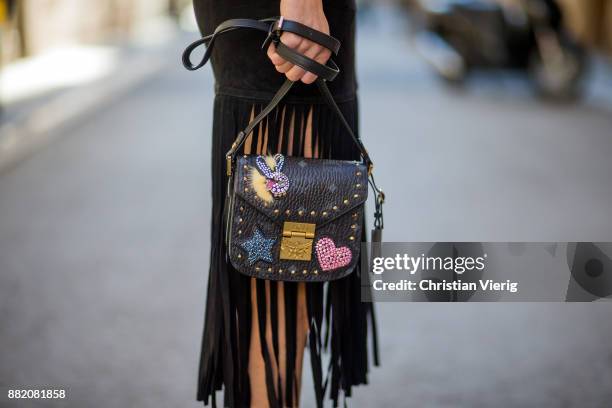 Alexandra Lapp wearing a suede leather fringe skirt in black from Set Fashion, light blue vintage jeans jacket by Levis, black lacquer waist belt by...
