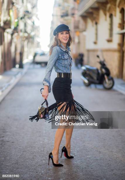 Alexandra Lapp wearing a suede leather fringe skirt in black from Set Fashion, light blue vintage jeans jacket by Levis, black lacquer waist belt by...