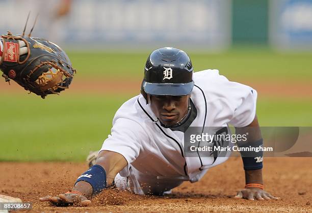Curtis Granderson of the Detroit Tigers dives back into first base against the Boston Red Sox during the game at Comerica Park on June 2, 2009 in...