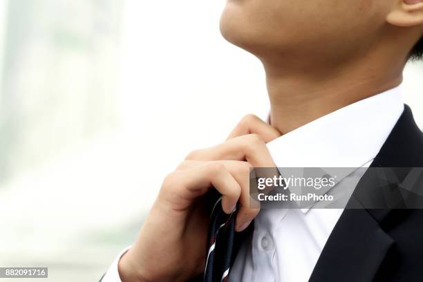 businessman adjusting tie, cropped - neck tie stock pictures, royalty-free photos & images