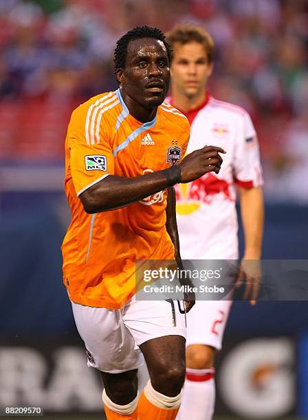 Ade Akinbiyi of the Houston Dynamo plays the ball against the New York Red Bulls at Giants Stadium in the Meadowlands on May 16, 2009 in East...