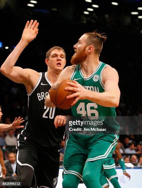 Aron Baynes of the Boston Celtics in action against Timofey Mozgov of the Brooklyn Nets at Barclays Center on November 14, 2017 in the Brooklyn...