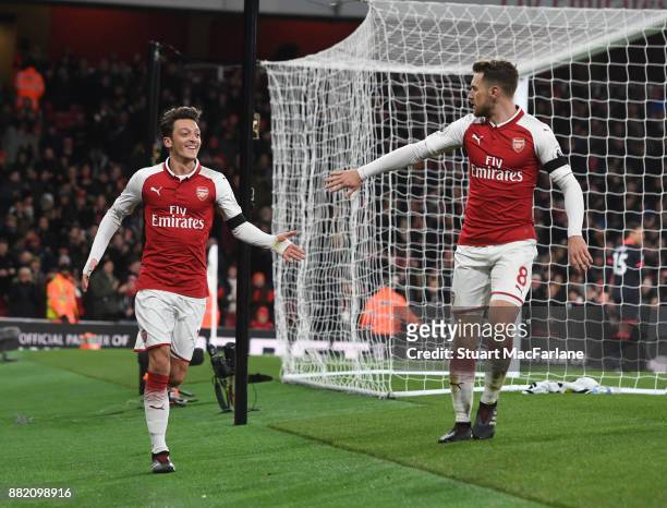 Mesut Ozil and Aaron Ramsey celebrate the 3rd Arsenal goal, scored by Alexis Sanchez during the Premier League match between Arsenal and Huddersfield...