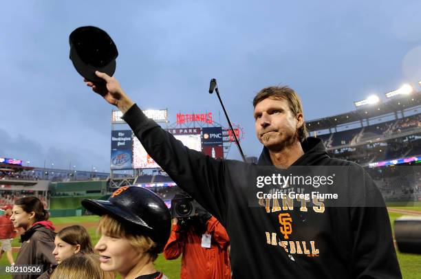 Randy Johnson of the San Francisco Giants tips his hat to the crowd after winning his 300th career game against the Washington Nationals at Nationals...