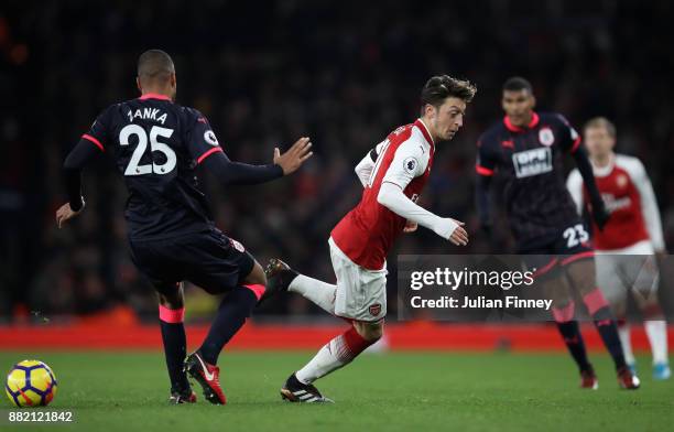 Mesut Ozil of Arsenal turns Mathias Jorgensen of Huddersfield Town during the Premier League match between Arsenal and Huddersfield Town at Emirates...