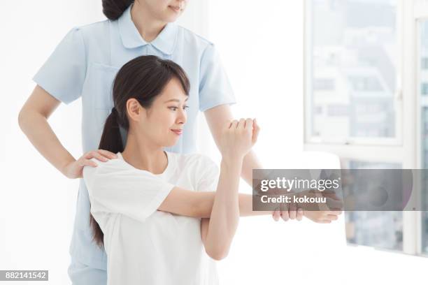 bending and stretching of arms. - physiotherapy asian stock pictures, royalty-free photos & images